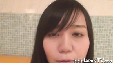 Smiling Japanese honey shaves bush and sprays golden pee on cam